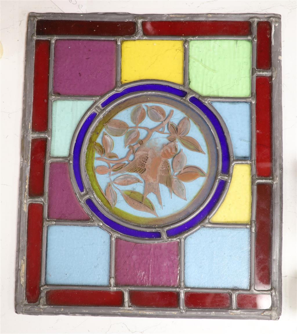 A rectangular stained glass and lead panel, bird roundel to centre, 35 x 30cm